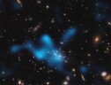 In azzurro la ricostruzione del gas che avvolge l'ammasso di galassie in formazione intorno alla galassia Spiderweb (fonte: ESO/Di Mascolo et al.; HST: H. Ford) (ANSA)