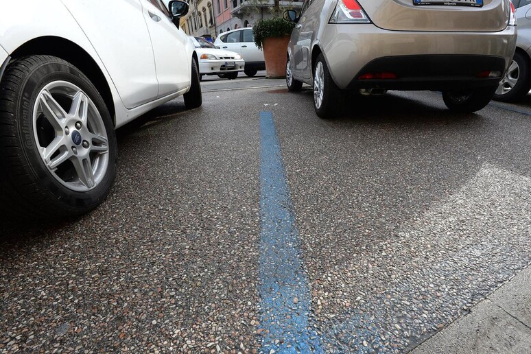 Un parcheggio con strisce blu - RIPRODUZIONE RISERVATA