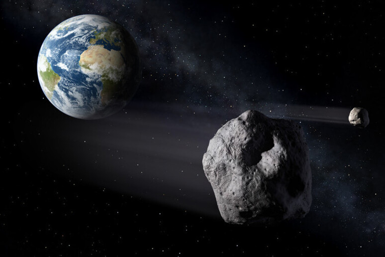 Rappresentazione asrtistica del passaggio di asteroidi vicini alla Terra (fonte: NASA) - RIPRODUZIONE RISERVATA