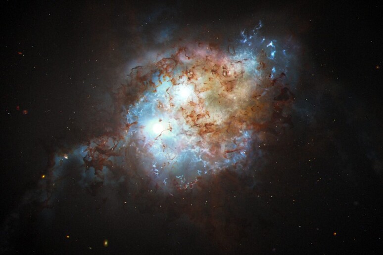 Rappresentazione artistica di due quasar all 'interno di due galassie in collisione (fonte: NASA, ESA, Joseph Olmsted/STScI) - RIPRODUZIONE RISERVATA